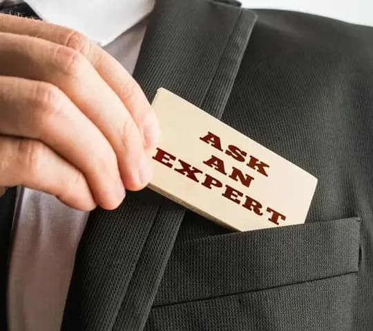 Man pulling out card that says Ask an Expert