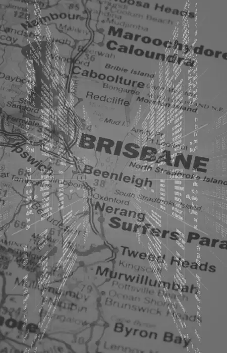 Programming code with Brisbane cityscape